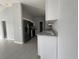 Modern kitchen with white cabinetry, granite countertops, stainless steel appliances, and tile flooring at 28 Bahia Pass Dr, Ocala, FL 34472