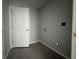 Functional laundry room with tile flooring, grey walls, and washer/dryer hookups, offering convenience at 28 Bahia Pass Dr, Ocala, FL 34472
