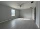 Bright main bedroom with tiled floors, a ceiling fan, and a window allowing natural light at 28 Bahia Pass Dr, Ocala, FL 34472