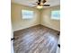 This cozy bedroom has wood-look floors and two windows at 2848 Se 11Th St, Ocala, FL 34471