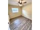 This cozy bedroom has wood-look floors, a ceiling fan, and a window at 2848 Se 11Th St, Ocala, FL 34471
