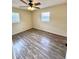 This cozy bedroom has wood-look floors and a ceiling fan at 2848 Se 11Th St, Ocala, FL 34471