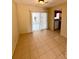 Tiled dining area with sliding glass doors to the screened porch and kitchen access at 2848 Se 11Th St, Ocala, FL 34471