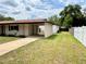 Exterior view of a house featuring a carport and a well-maintained lawn at 2848 Se 11Th St, Ocala, FL 34471