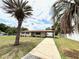 Inviting single-story home featuring a covered carport and a well-manicured lawn at 2848 Se 11Th St, Ocala, FL 34471