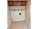 Functional laundry area with tiled floor, shelving, and washer/dryer hookups at 2848 Se 11Th St, Ocala, FL 34471