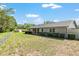 Expansive backyard featuring a well-maintained lawn, mature trees, and a secure fence for added privacy at 3950 Se 10Th Ln, Ocala, FL 34471