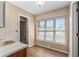 Bathroom featuring wood-look floors, neutral walls, and a large window at 3950 Se 10Th Ln, Ocala, FL 34471