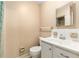 Traditional bathroom with white vanity, toilet, and tiled shower with a peach painted wall at 3950 Se 10Th Ln, Ocala, FL 34471