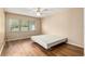Bright bedroom featuring hardwood floors and a large window with natural light at 3950 Se 10Th Ln, Ocala, FL 34471