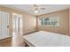 Bedroom with wood-look floors, neutral walls, ceiling fan, and natural light at 3950 Se 10Th Ln, Ocala, FL 34471
