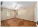 Bedroom with neutral walls, two windows, carpet, and a ceiling fan at 3950 Se 10Th Ln, Ocala, FL 34471