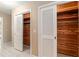 Hallway showcases cedar-lined closets with white, louvered doors and neutral paint at 3950 Se 10Th Ln, Ocala, FL 34471
