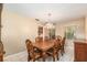 Elegant dining room with a chandelier and views into the kitchen at 3950 Se 10Th Ln, Ocala, FL 34471