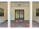Inviting covered entrance with double doors, brick tile, and decorative lighting creates a warm welcome at 3950 Se 10Th Ln, Ocala, FL 34471