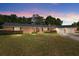 Charming brick ranch home with a well-maintained front yard and mature trees at 3950 Se 10Th Ln, Ocala, FL 34471