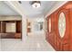 Foyer with tile flooring leading to an open floor plan, showcasing a stone fireplace and kitchen at 3950 Se 10Th Ln, Ocala, FL 34471