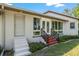 A welcoming front entrance features a brick steps and railing and windows for lots of natural light at 3950 Se 10Th Ln, Ocala, FL 34471