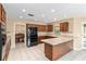 Well-equipped kitchen with dark wood cabinets, granite countertops, and modern appliances at 3950 Se 10Th Ln, Ocala, FL 34471