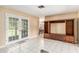 Living room with tile flooring, a large TV console, and French doors at 3950 Se 10Th Ln, Ocala, FL 34471