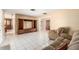 Living room featuring tile flooring, neutral walls, a TV console, and comfortable seating at 3950 Se 10Th Ln, Ocala, FL 34471