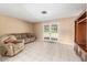 Bright living room with tile floors, neutral walls, and French doors at 3950 Se 10Th Ln, Ocala, FL 34471