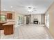 Open-concept living room featuring tile flooring, a stone fireplace, and kitchen access at 3950 Se 10Th Ln, Ocala, FL 34471