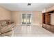 Spacious living room with tile floors and sliding glass doors to the backyard at 3950 Se 10Th Ln, Ocala, FL 34471