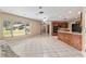 Open-concept living area connected to the kitchen with tile flooring and natural light at 3950 Se 10Th Ln, Ocala, FL 34471