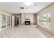 Cozy living room featuring a striking stone fireplace and large windows at 3950 Se 10Th Ln, Ocala, FL 34471