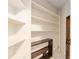 View of a pantry featuring white shelves and a dark shelving unit at 3950 Se 10Th Ln, Ocala, FL 34471