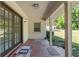 Back porch features decorative tile, a stylish double-doored entry, and a view of the backyard at 3950 Se 10Th Ln, Ocala, FL 34471