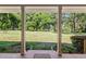 Back porch with a view of the expansive backyard and mature trees at 3950 Se 10Th Ln, Ocala, FL 34471