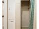 Tiled shower stall with a showerhead, grab bar, and curtain with white and blue circle pattern at 3950 Se 10Th Ln, Ocala, FL 34471
