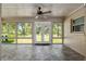 Enclosed sunroom with tile flooring, ceiling fan and multiple windows that let in natural light at 3950 Se 10Th Ln, Ocala, FL 34471