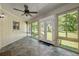 Bright sunroom features multiple windows, tile flooring, ceiling fan and exit to backyard at 3950 Se 10Th Ln, Ocala, FL 34471