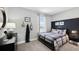 Nicely decorated bedroom with a plaid comforter, natural light, and charming accents at 4301 Sw 54Th Street Rd, Ocala, FL 34474