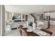 Open-concept living space with modern decor, a kitchen island, and a staircase to the second floor at 4301 Sw 54Th Street Rd, Ocala, FL 34474