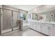 Bright bathroom featuring a glass-enclosed shower, soaking tub, double vanity and modern finishes at 4317 Sw 54Th Street Rd, Ocala, FL 34474