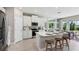 Bright, modern kitchen with white cabinets, stainless steel appliances, and large windows at 4317 Sw 54Th Street Rd, Ocala, FL 34474