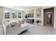 Bright living room featuring large windows, a comfortable sofa, and stylish decor at 4317 Sw 54Th Street Rd, Ocala, FL 34474