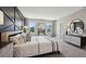 Inviting main bedroom featuring a geometric accent wall, large windows, and elegant decor at 4317 Sw 54Th Street Rd, Ocala, FL 34474
