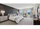 Serene main bedroom with stylish accent wall, large windows, and modern furnishings at 4317 Sw 54Th Street Rd, Ocala, FL 34474
