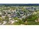 Wide aerial view showcasing a charming residential area with a golf course amid lush greenery at 514 Saint Andrews Blvd, Lady Lake, FL 32159