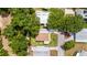 Aerial view of a well-maintained home featuring a brown roof and lush landscaping at 514 Saint Andrews Blvd, Lady Lake, FL 32159