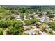 Scenic aerial view of a neighborhood with mature trees and well-kept single Gathering homes at 514 Saint Andrews Blvd, Lady Lake, FL 32159