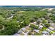 Aerial view of a tranquil residential area with mature trees and well-maintained homes at 514 Saint Andrews Blvd, Lady Lake, FL 32159