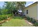 Spacious backyard with lush greenery, garden beds, and a charming gazebo, ideal for outdoor enjoyment at 514 Saint Andrews Blvd, Lady Lake, FL 32159
