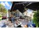 A covered patio featuring outdoor seating, a table with tile detail, and a golf cart, perfect for relaxation at 514 Saint Andrews Blvd, Lady Lake, FL 32159