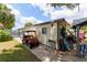 Home exterior with a golf cart parked outside, complemented by landscaping and backyard at 514 Saint Andrews Blvd, Lady Lake, FL 32159
